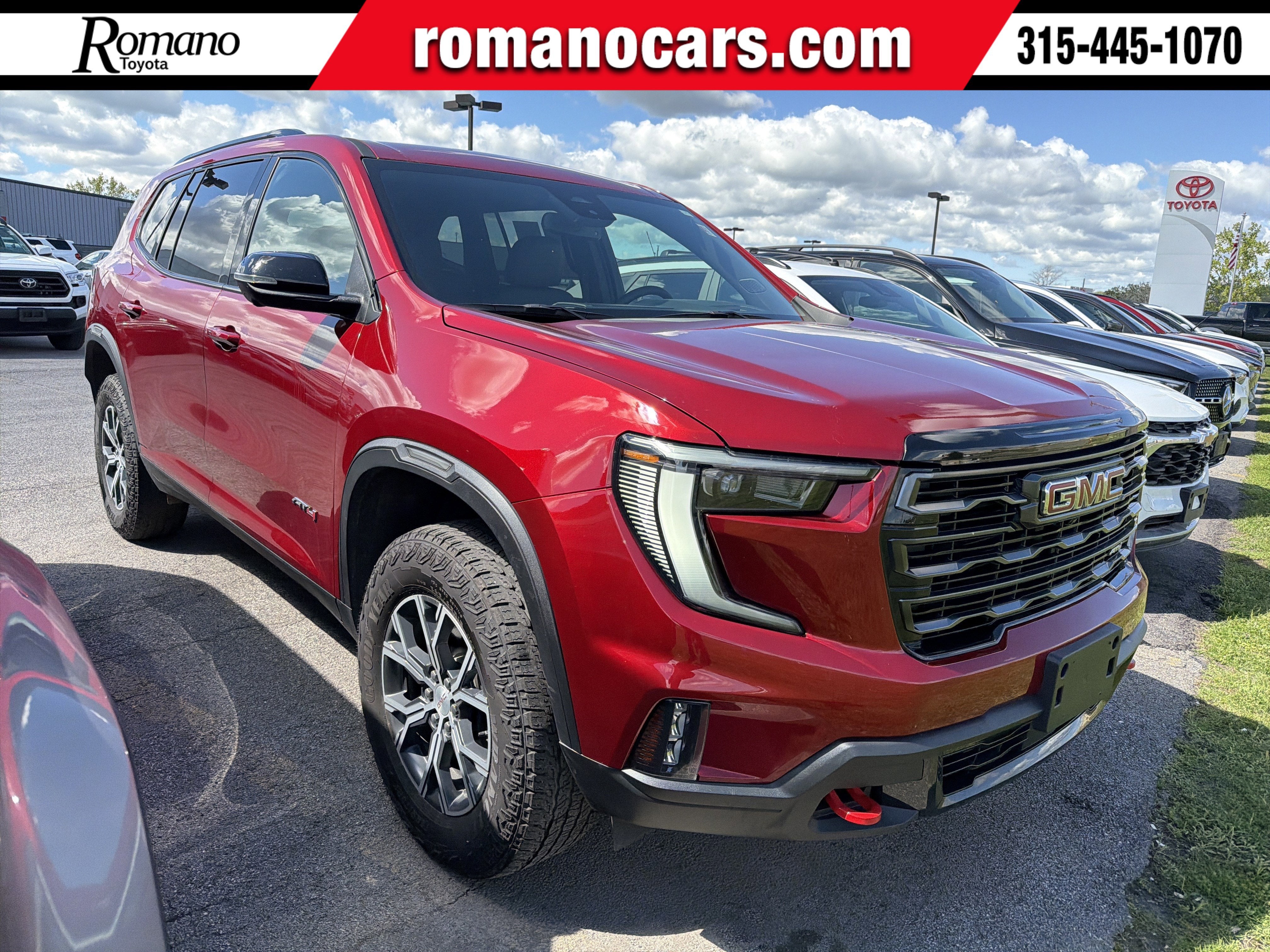 2025 GMC Acadia AWD AT4 in Volcanic Red Tintcoat — front three-quarter view