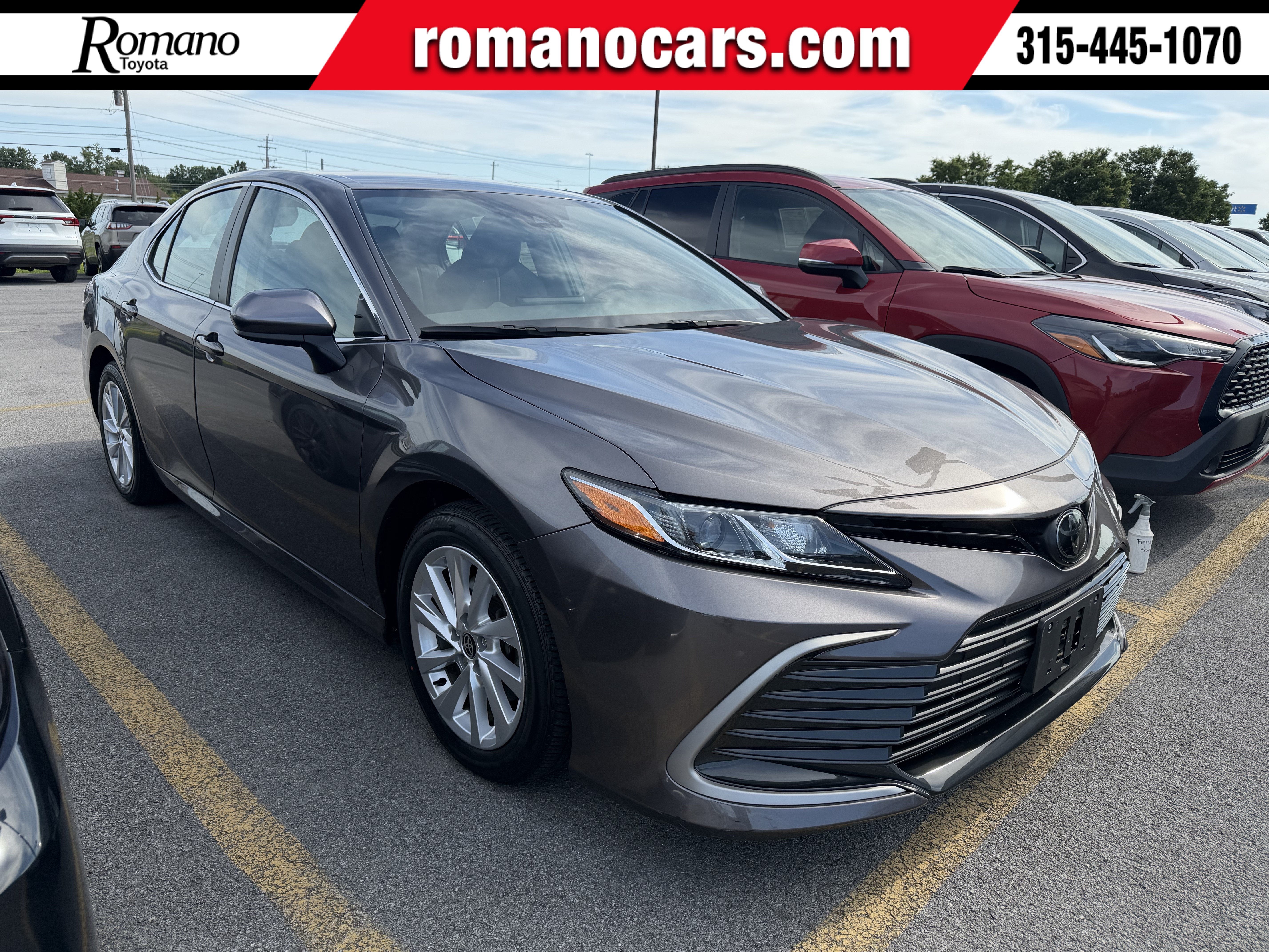 2023 Toyota Camry LE in Predawn Gray Mica — front three-quarter view